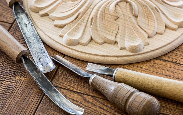 Wood processing. Joinery work. wood carving. a wood carvings, tools on the wooden background close up.  use as background