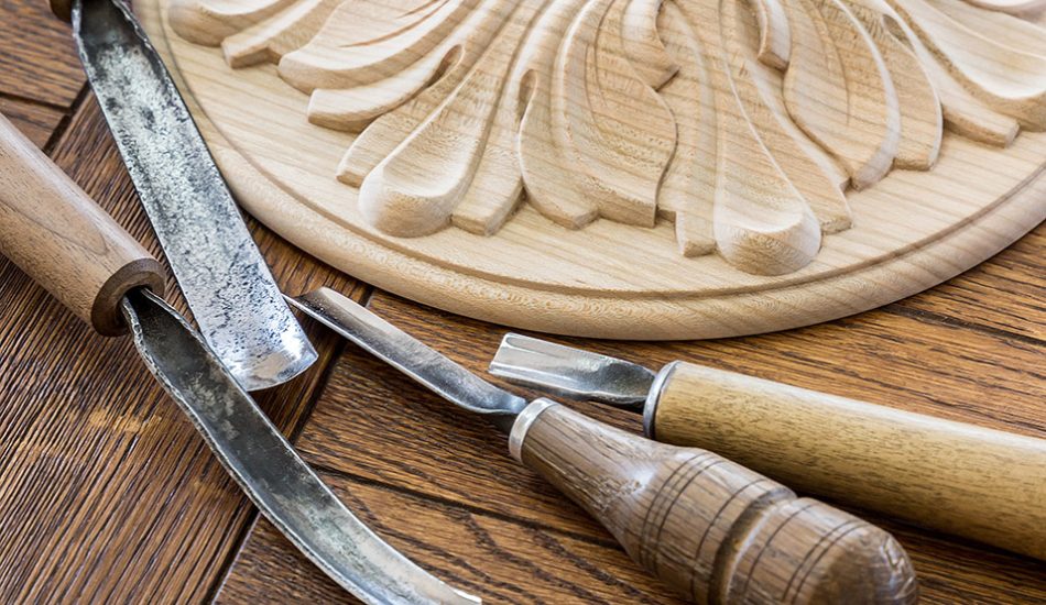 Wood processing. Joinery work. wood carving. a wood carvings, tools on the wooden background close up.  use as background